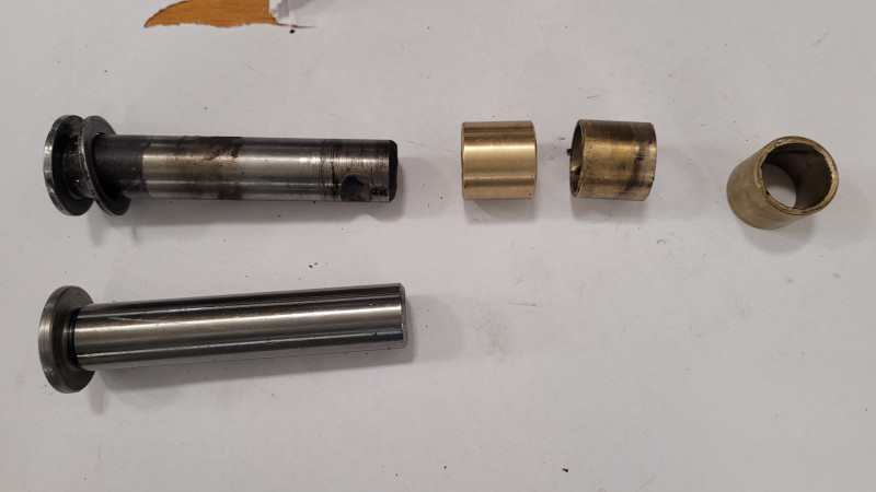 New and old center pin with bushings. Pretty straight forward to install, drive the bushings out and in, ream to size, install, grease. Still a grimy job, though.